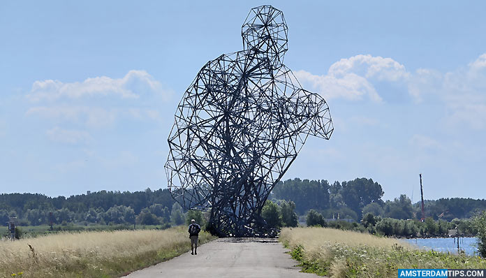 man walking towards antony gormley's exposure sculpture