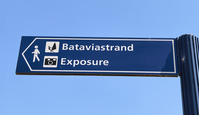 Signpost giving directions to Exposure sculpture and Bataviastrand in lelystad
